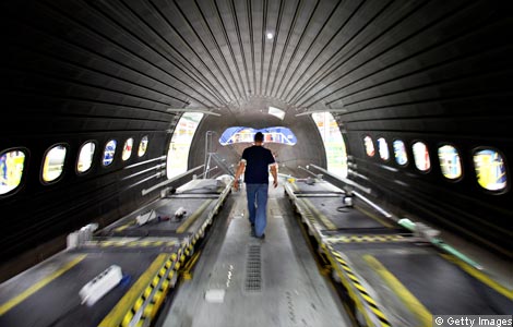 a worker inside a boeing 787 fuselage